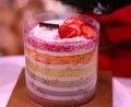 Corlorful rainbow strawberry cakes with white cream and a decoration of chocolate in Paris Baguette bakery store