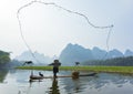 Cormorant, fish man and Li River scenery sight with fog in spring, Guilin, China