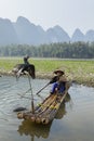 Cormorant, fish man and Li River scenery sight with fog in spring, Guilin, China