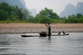 Cormorant fisherman and his birds on the Li River in Yangshuo, Guangxi, China Royalty Free Stock Photo