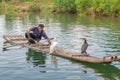 Cormorant fisherman and his birds on the Li River in Yangshuo, Guangxi, China.