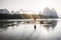 Cormorant fisherman throwing a net