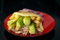 Corn arepas stuffed with beef, chicken breast, pork ham, mozzarella cheese and avocado