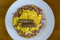 Corn beef hash top with scrambled eggs and sausage Royalty Free Stock Photo