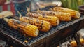 Grilled corn on a barbecue emitting smoke Royalty Free Stock Photo