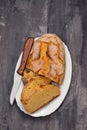 Corn bread with knife on white dish Royalty Free Stock Photo