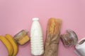 Corn, buckwheat, bananas, milk, bread in white bag on blue background