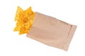 Corn chips or nachos  spill out of the small package  isolated on white background top view Royalty Free Stock Photo