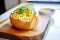 corn chowder in bread bowl with melted cheese Royalty Free Stock Photo