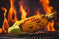 Corn on the cob cooking on a fiery BBQ grill