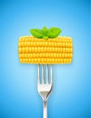 Corn cob at fork. Organic food. Royalty Free Stock Photo