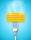 Corn cob at fork. Organic food. Royalty Free Stock Photo