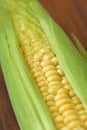 Corn on cob on rustic wooden table and wooden background from a natural wooden. Golden bright yellow corn. Tasty and healthy food Royalty Free Stock Photo