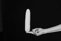 Corn cob in yellow color in girls fingers. Female hand holds corn isolated on black background