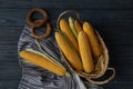 Corn cobs on dark wooden table Royalty Free Stock Photo