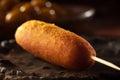 A corn dog on a stick with a stick in the background AI generation