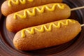 Corn dog street junk food deep fried hotdog meat sausage snack with mustard Royalty Free Stock Photo