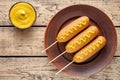 Corn dog traditional American corndog junk food fried hotdog meat sausage snack with mustard Royalty Free Stock Photo