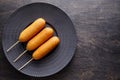 Corn dog traditional American corndog street food on dark rustic table