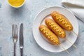 Corn dog traditional American corndog street food deep fried hotdog meat sausage snack with mustard on top Royalty Free Stock Photo