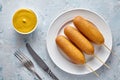 Corn dog traditional American corndog street junk food deep fried hotdog meat sausage snack on stick with mustard Royalty Free Stock Photo