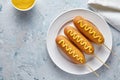 Corn dog traditional American corndog street junk food fried hotdog meat sausage snack with mustard on top Royalty Free Stock Photo