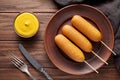 Corn dog traditional American corndog street junk food fried hotdog meat sausage snack with mustard Royalty Free Stock Photo