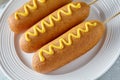 Corn dog traditional American food fried hotdog meat wiener with mustard on top Royalty Free Stock Photo