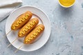 Corn dog traditional American street food deep fried hot meat sausage snack with yellow mustard Royalty Free Stock Photo