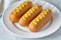Corn dog traditional American street junk food deep fried hotdog meat sausage snack with mustard