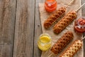 Corn dogs, mustard, ketchup and barbecue sauce Royalty Free Stock Photo