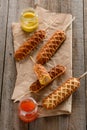 Corn dogs, mustard and ketchup on kraft wrapping paper Royalty Free Stock Photo