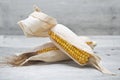 Corn ears on a wooden background