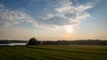 Corn field agriculture under a sunset sky. Green nature. Rural farm land in summer. Plant growth. Farming scene. Outdoor Royalty Free Stock Photo