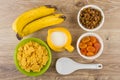 Corn flakes, bananas, jug milk, dried apricots, raisins and spoon Royalty Free Stock Photo