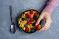 Corn flakes with berries in black bowl Royalty Free Stock Photo
