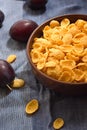 Corn flakes in a bowl with fruit, close-up