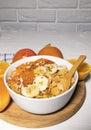 Corn Flakes Bowl with Milk, Persimmon, Orange on Wooden board on white background, Healthy Breakfast Royalty Free Stock Photo