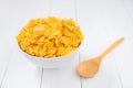 Corn flakes bowl with spoon on white wooden Royalty Free Stock Photo