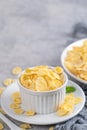 Corn flakes bowl sweeties with milk on gray cement background Royalty Free Stock Photo