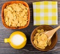 Corn flakes in bowls, napkin and jug milk on table Royalty Free Stock Photo