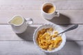 Corn Flakes cereal in a bowl, glass with milk and cap with espresso coffee. Morning breakfast. Royalty Free Stock Photo