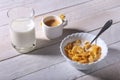 Corn Flakes cereal in a bowl, glass with milk and cap with espresso coffee. Morning breakfast. Royalty Free Stock Photo