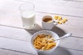 Corn Flakes cereal in a bowl, glass with milk and cap with espresso coffee. Morning breakfast. Royalty Free Stock Photo