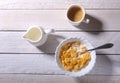 Corn Flakes cereal in a bowl, glass with milk and cap with espresso coffee. Morning breakfast. Royalty Free Stock Photo