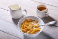 Corn Flakes cereal in a bowl, glass with milk and cap with espresso coffee. Morning breakfast. Royalty Free Stock Photo