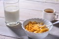 Corn Flakes cereal in a bowl, glass with milk and cap with espresso coffee. Morning breakfast. Royalty Free Stock Photo