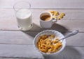 Corn Flakes cereal in a bowl, glass with milk and cap with espresso coffee. Morning breakfast. Royalty Free Stock Photo