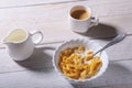 Corn Flakes cereal in a bowl, glass with milk and cap with espresso coffee. Morning breakfast. Royalty Free Stock Photo