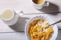 Corn Flakes cereal in a bowl, glass with milk and cap with espresso coffee. Morning breakfast. Royalty Free Stock Photo